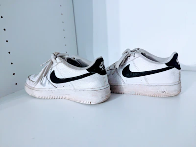 A sleek pair of classic second-hand running shoes with visible character and style.