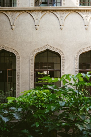 Close-up of the elegant facade of Piramal Revanta with lush greenery.