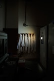 a row of white robes hanging on a wall