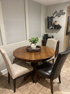 A cozy kitchen corner with warm suede and brown tones, featuring elegant home and dining essentials.