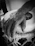 Close-up of hands skillfully playing a djembe drum, bathed in warm terracotta light.