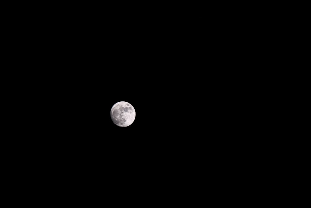 a view of the moon in the dark sky