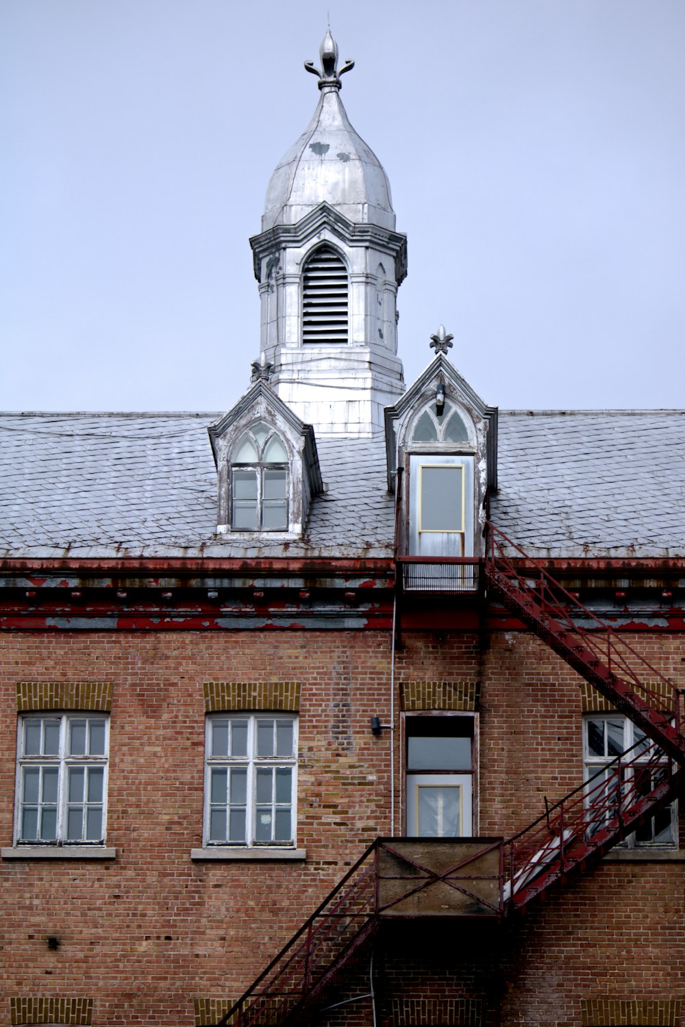 a tall brick building with a steeple on top