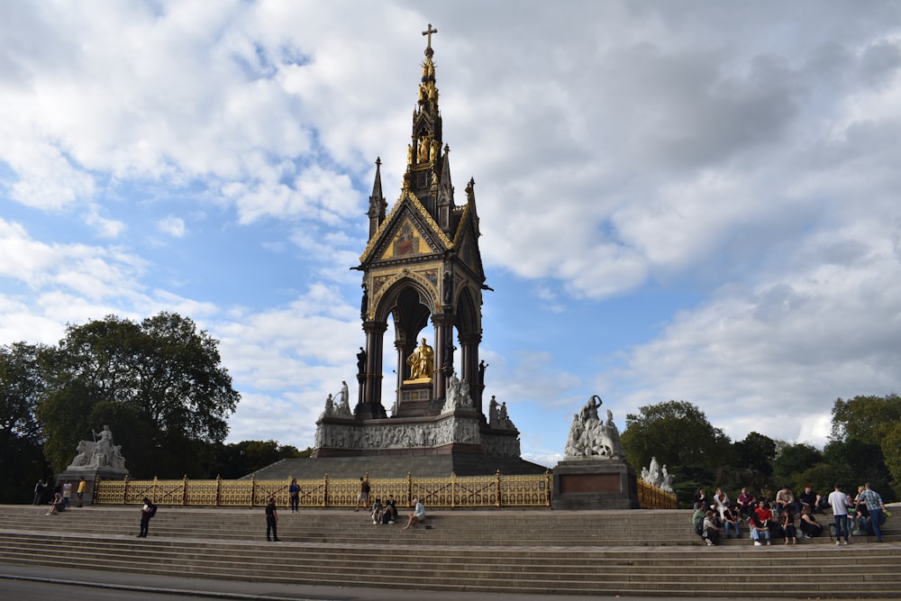 a group of people standing in front of a monument