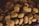 A close-up view of a pile of dry brown pet food, with irregularly shaped pieces in varying shades of brown.