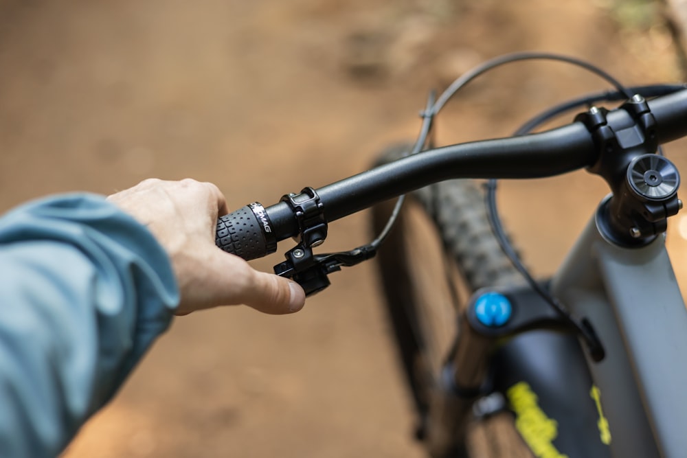 a close up of a person's hand on the handlebars of a