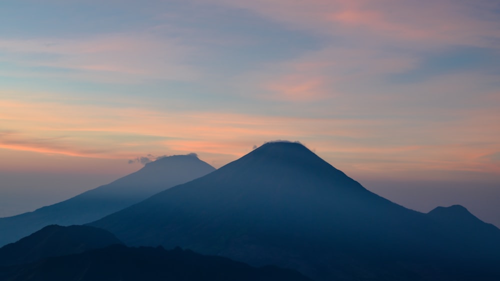 a view of a mountain at sunset from a plane