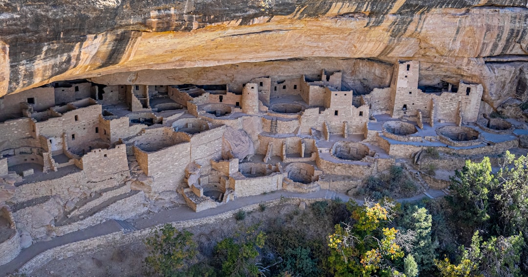 a cliff with a cliff house built into the side of it,