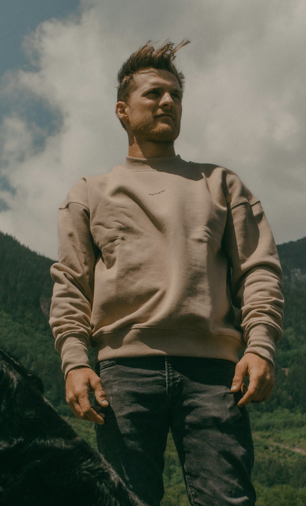 a man standing in front of a mountain