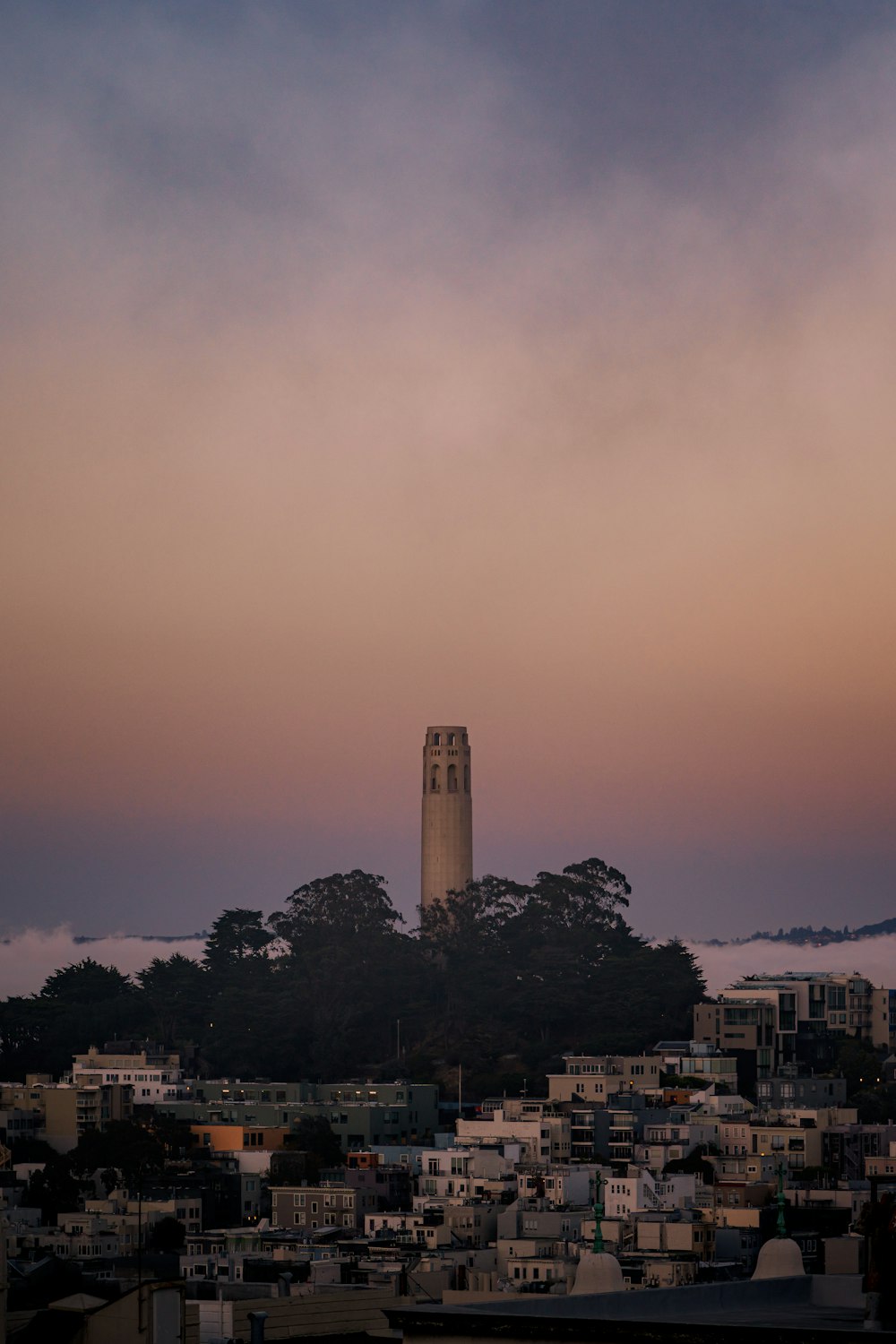 a very tall clock tower towering over a city