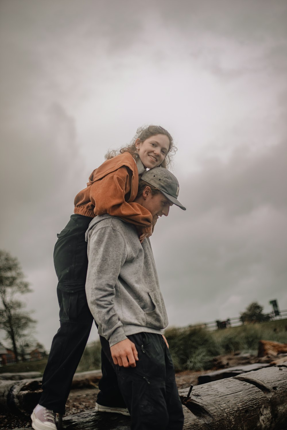 a man carrying a woman on his back