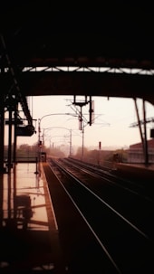a train station with a train on the tracks