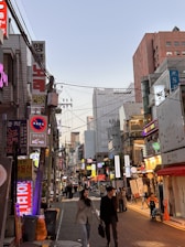 A vibrant street scene in Seoul showcasing trendy clothing shops and bustling fashion culture.