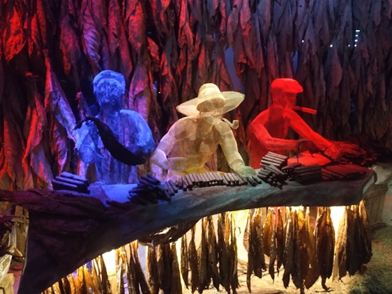 Close-up of a skilled artisan hand-rolling a Don Mario cigar in a warm, rustic Ybor City workshop.