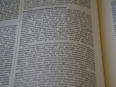 A close-up of an open book with pages turning, representing knowledge and guidance.