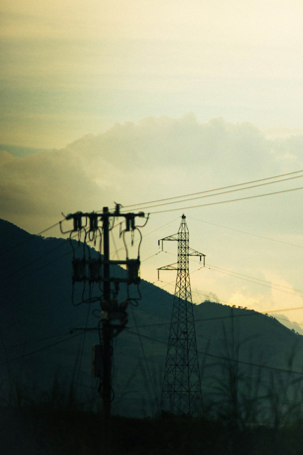 a view of a mountain with power lines in the foreground