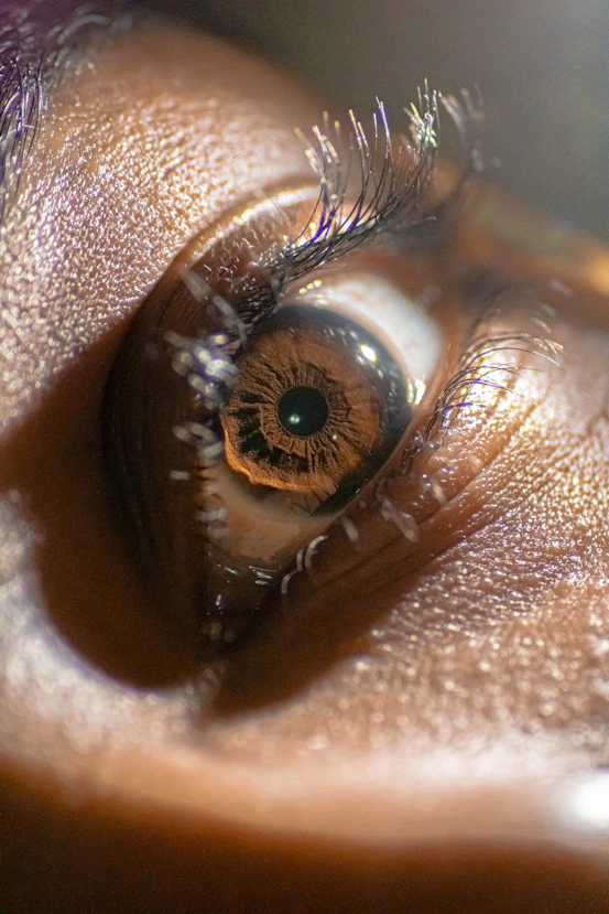 a close up of a person's brown eye