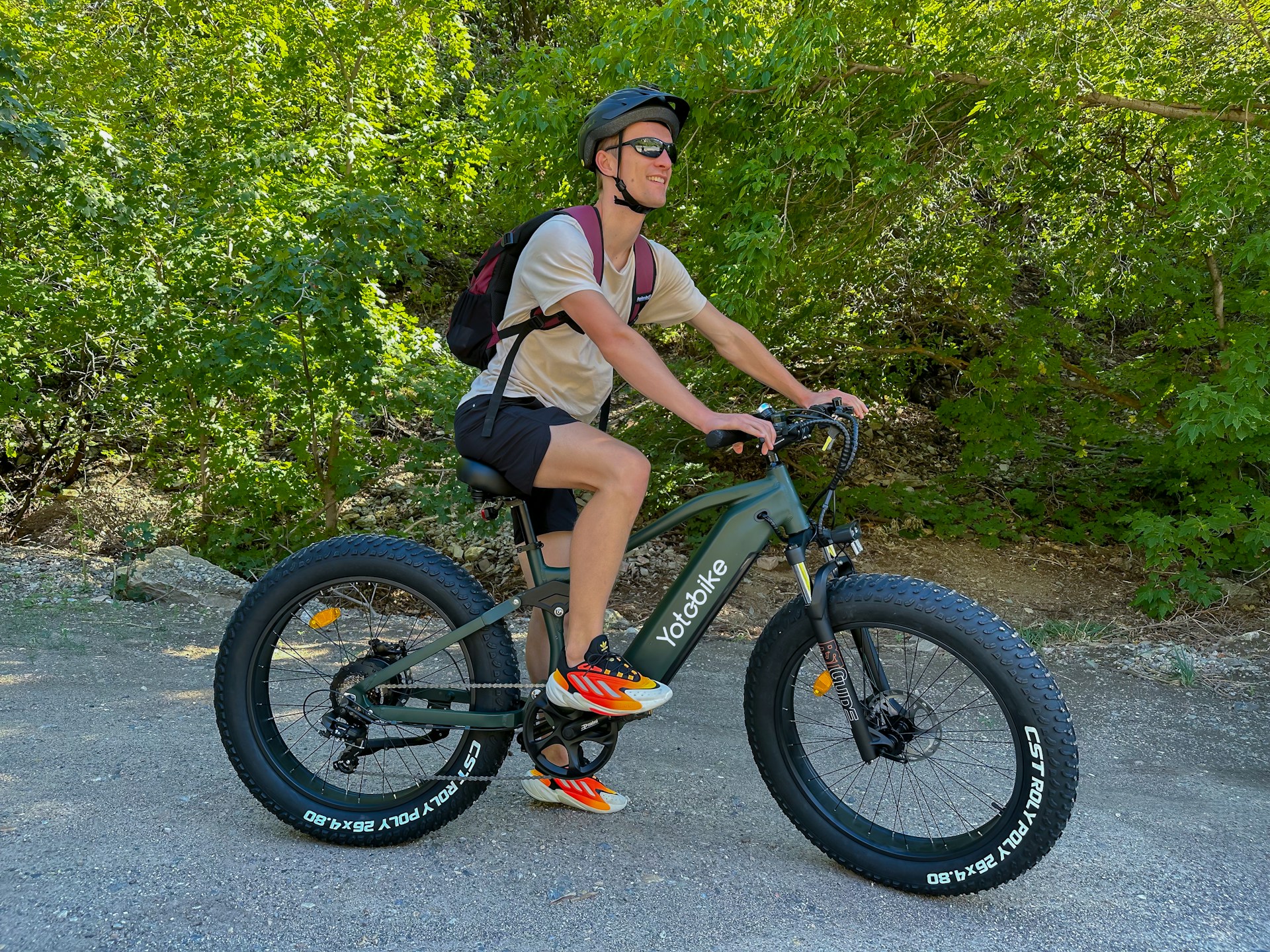 Dynamic shot of a rider enjoying an electric bike on a scenic trail surrounded by greenery