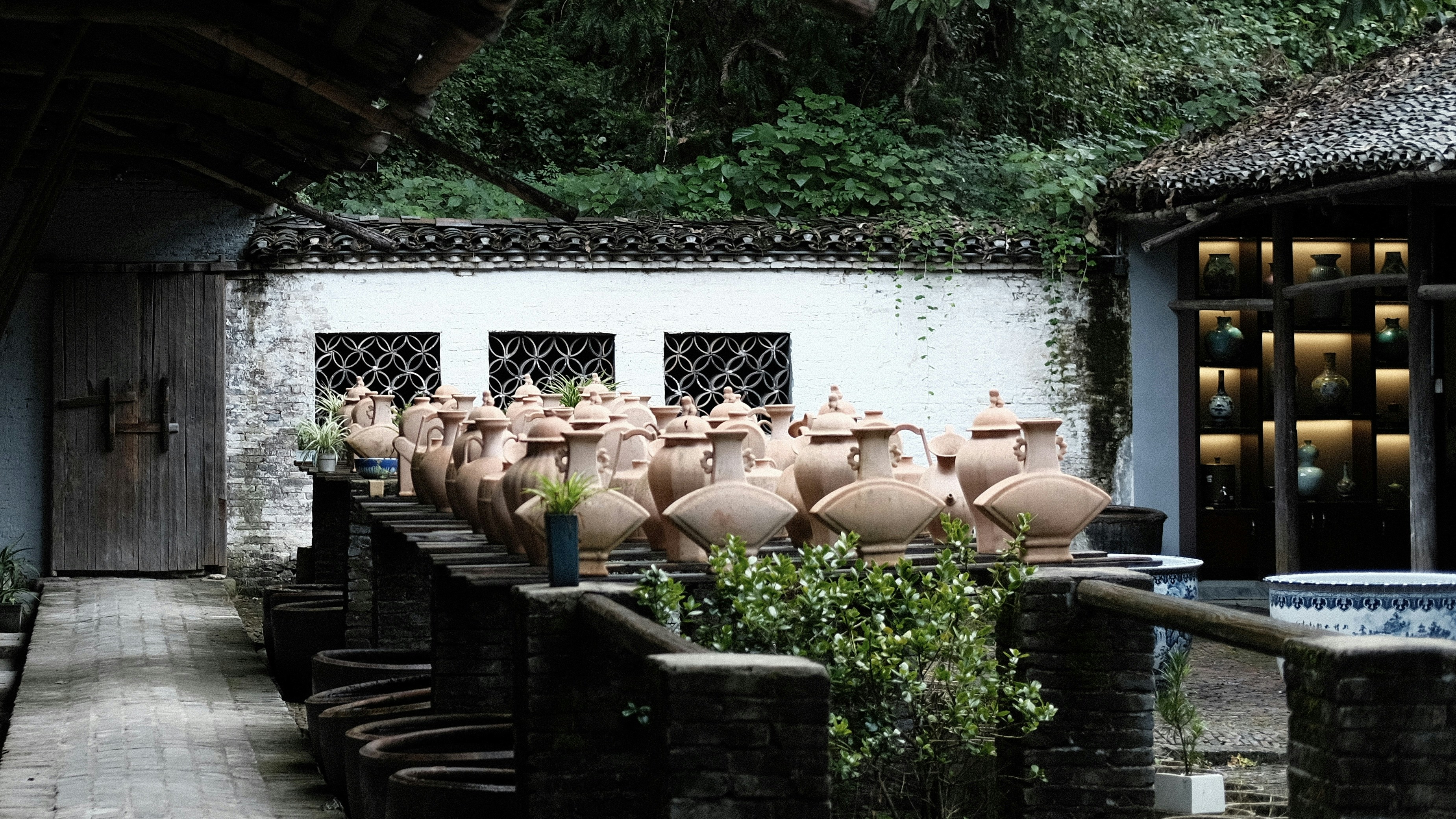 a row of vases in front of a building
