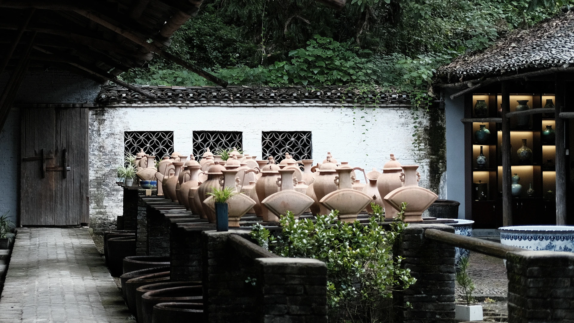 a row of vases in front of a building