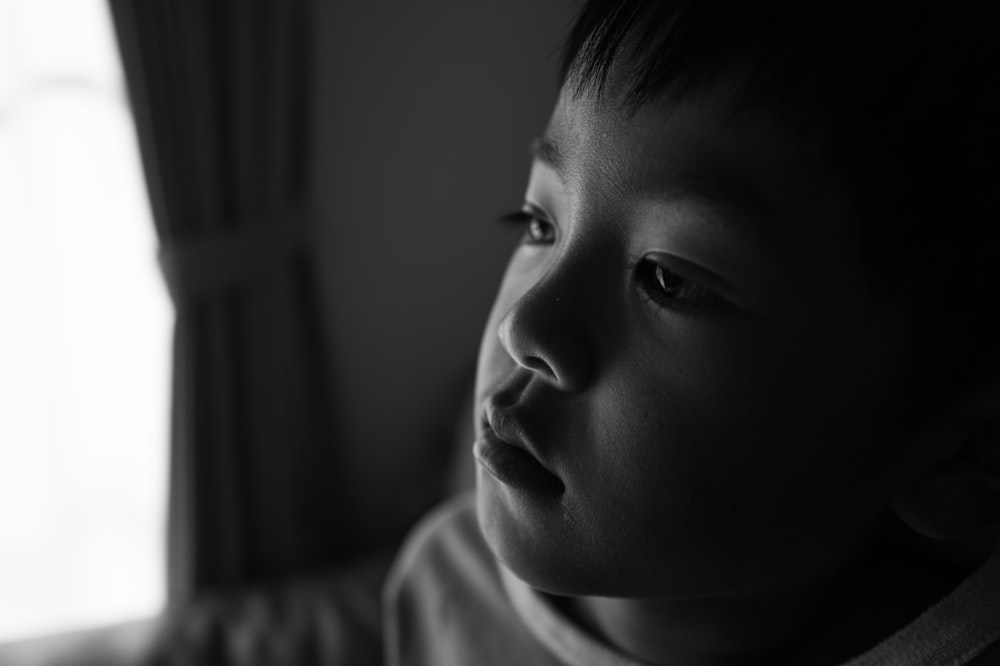 a black and white photo of a young boy