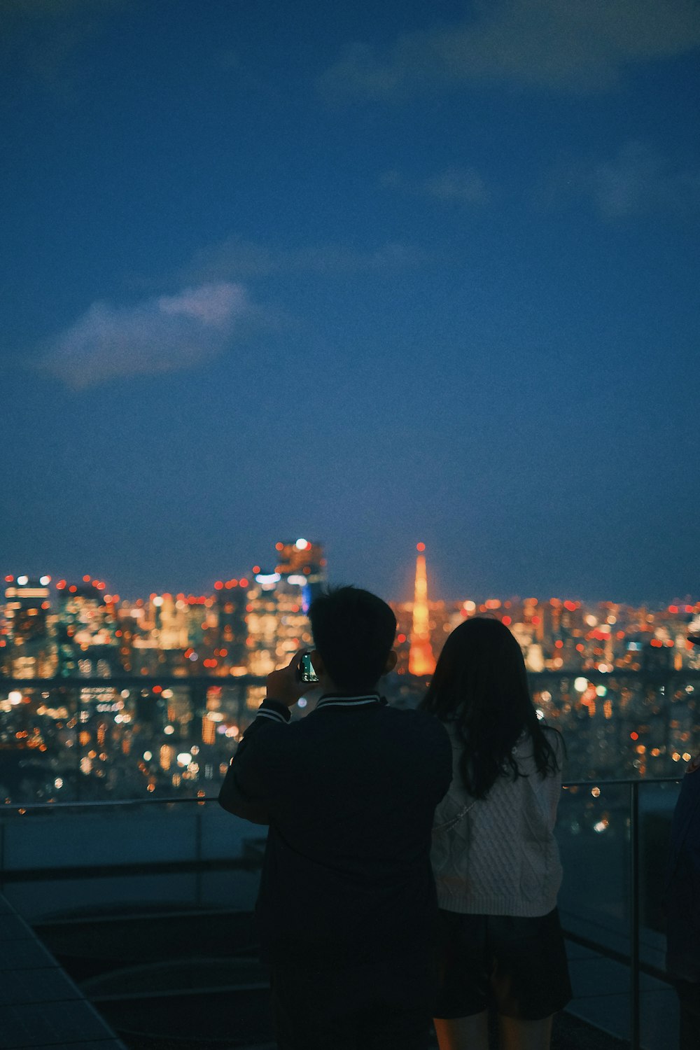 a couple of people that are looking at a city