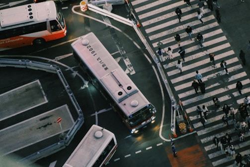 Aerial view of a busy transportation hub with buses and trains.