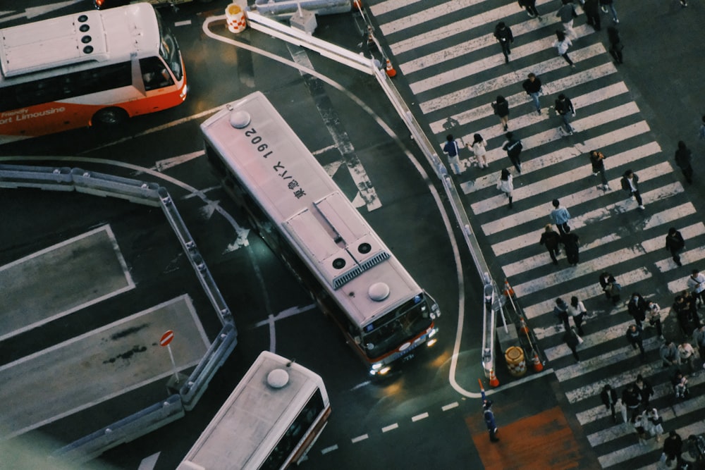 an overhead view of a city street with buses and pedestrians