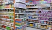 Shelves filled with a variety of packaged products, including snacks and pet food. The left side features chips and snacks in colorful bags, while the right side displays pet food bags and cans. The items are neatly organized, offering a vibrant and busy visual.