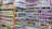 Shelves filled with a variety of packaged products, including snacks and pet food. The left side features chips and snacks in colorful bags, while the right side displays pet food bags and cans. The items are neatly organized, offering a vibrant and busy visual.