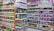 Shelves filled with a variety of packaged products, including snacks and pet food. The left side features chips and snacks in colorful bags, while the right side displays pet food bags and cans. The items are neatly organized, offering a vibrant and busy visual.