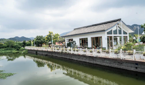 A modern house with large windows overlooking the valley and river.