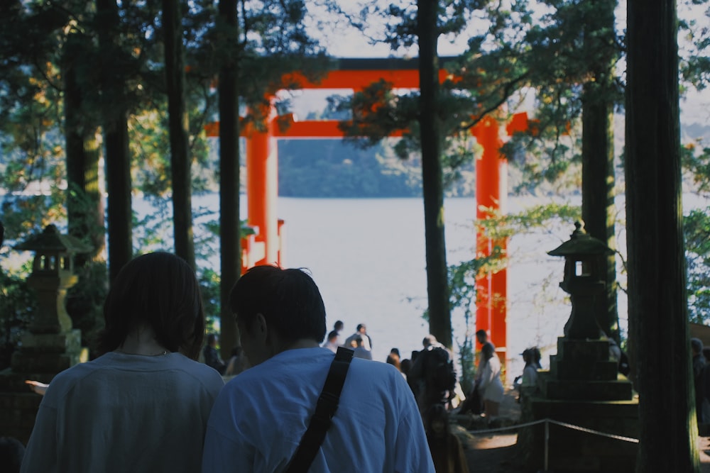 a couple of people that are standing in front of a gate