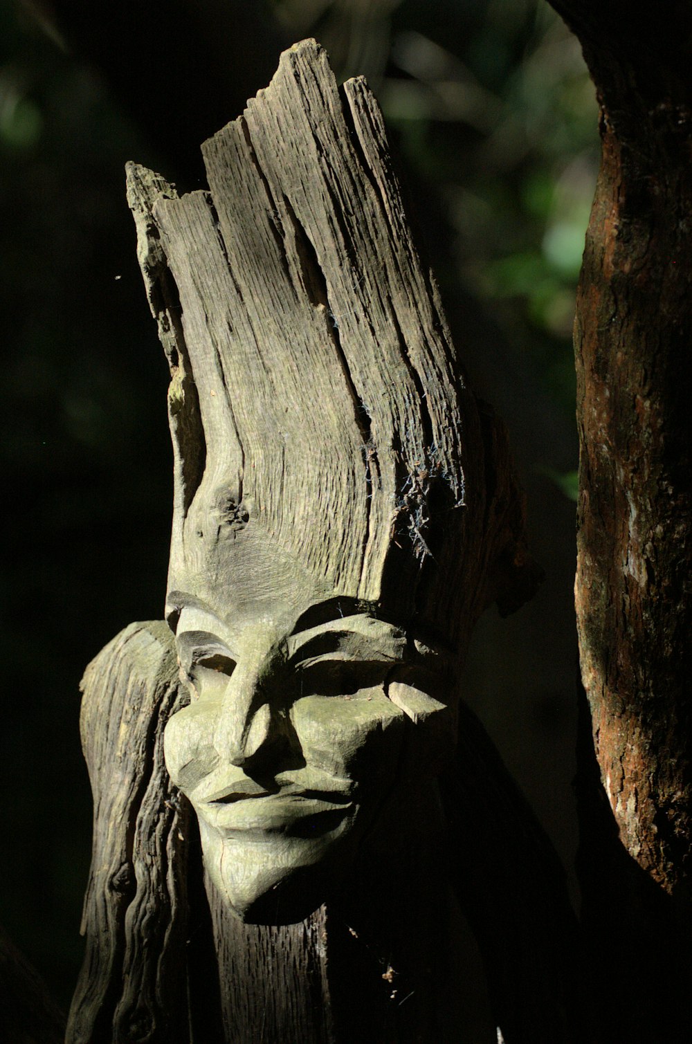 a wooden statue of a person with a face