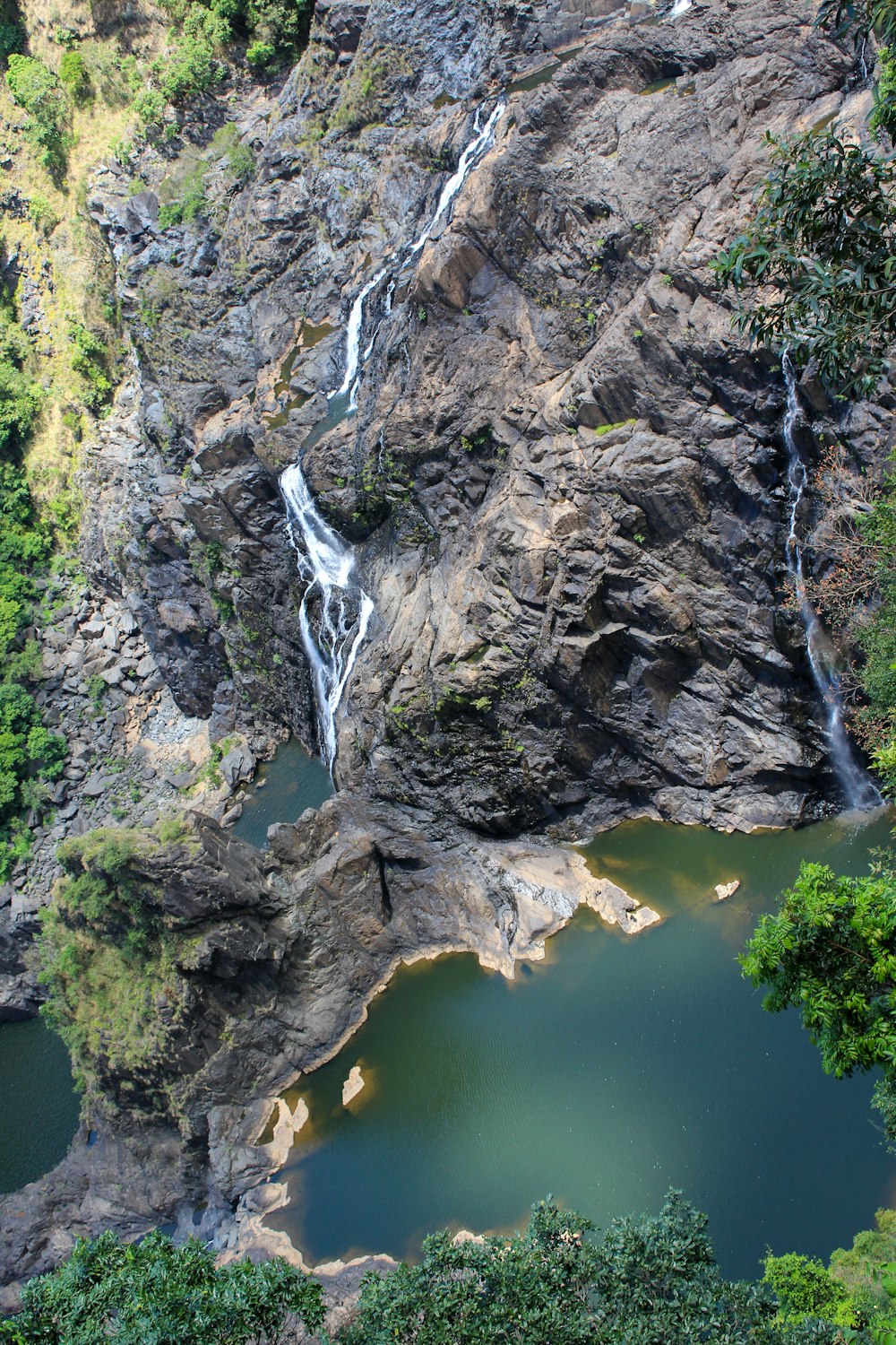 an aerial view of a waterfall and a lake