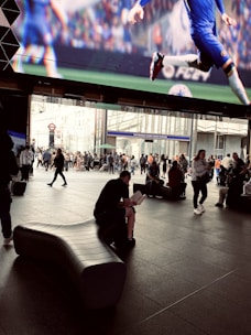 A passionate football fan reading match analysis on a tablet.