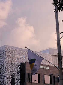 A professional Pakistani bank building with the national flag colors subtly reflected in the design.