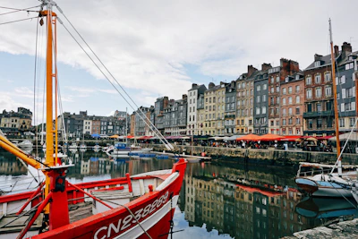a red and white boat docked in a harbor