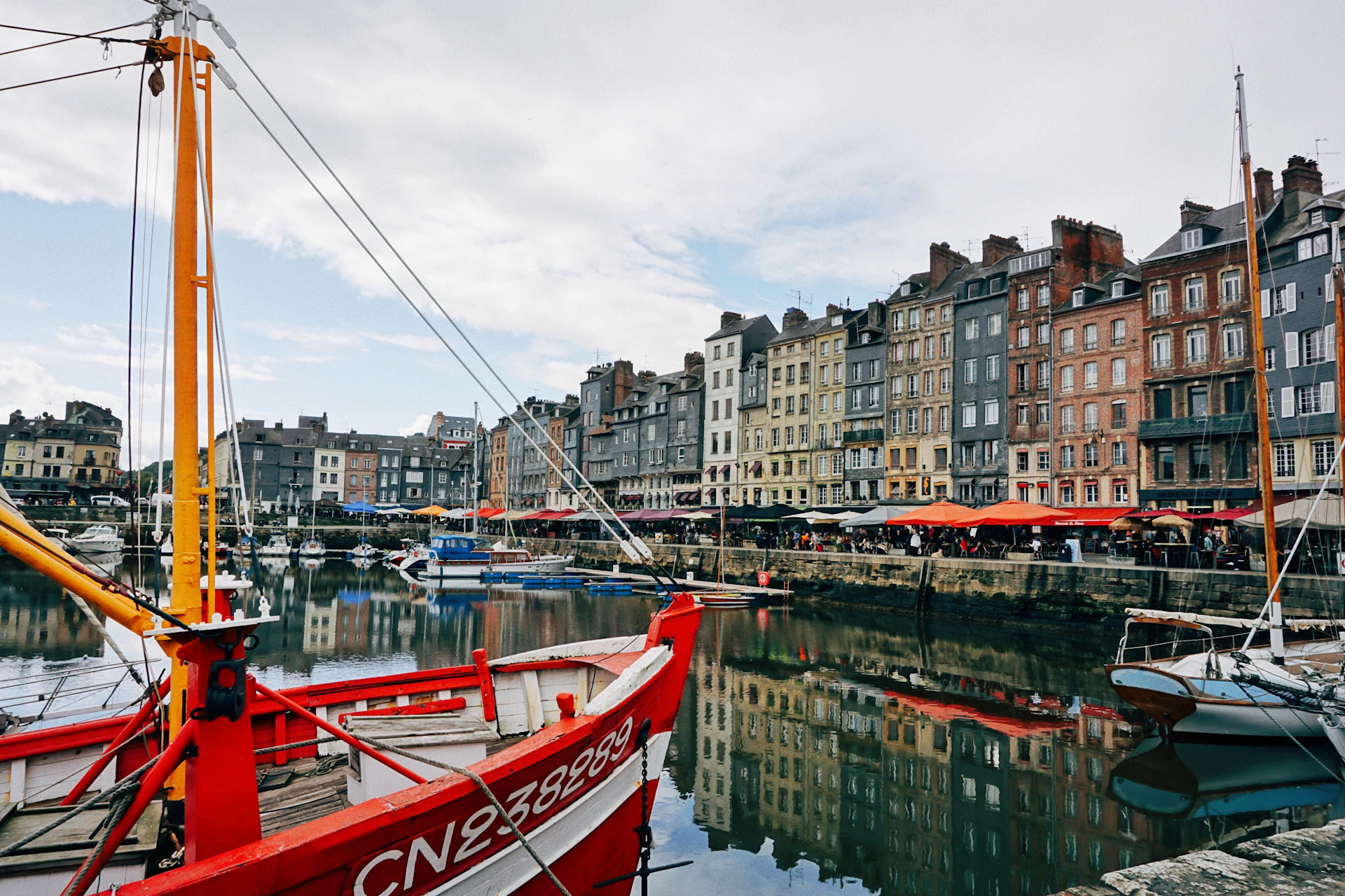 a red and white boat docked in a harbor