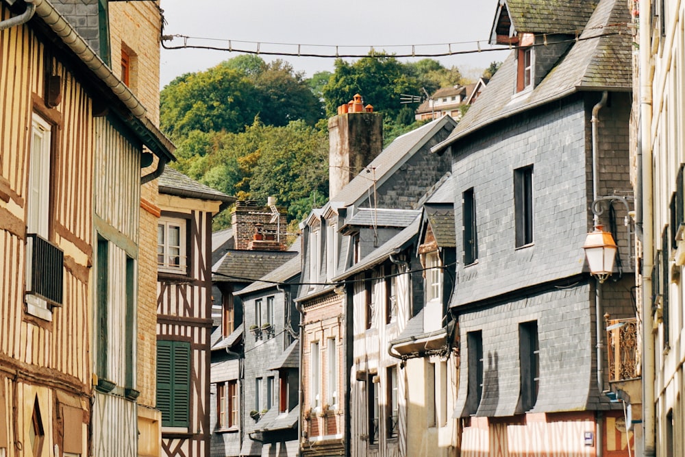 a row of buildings with a clock tower in the background