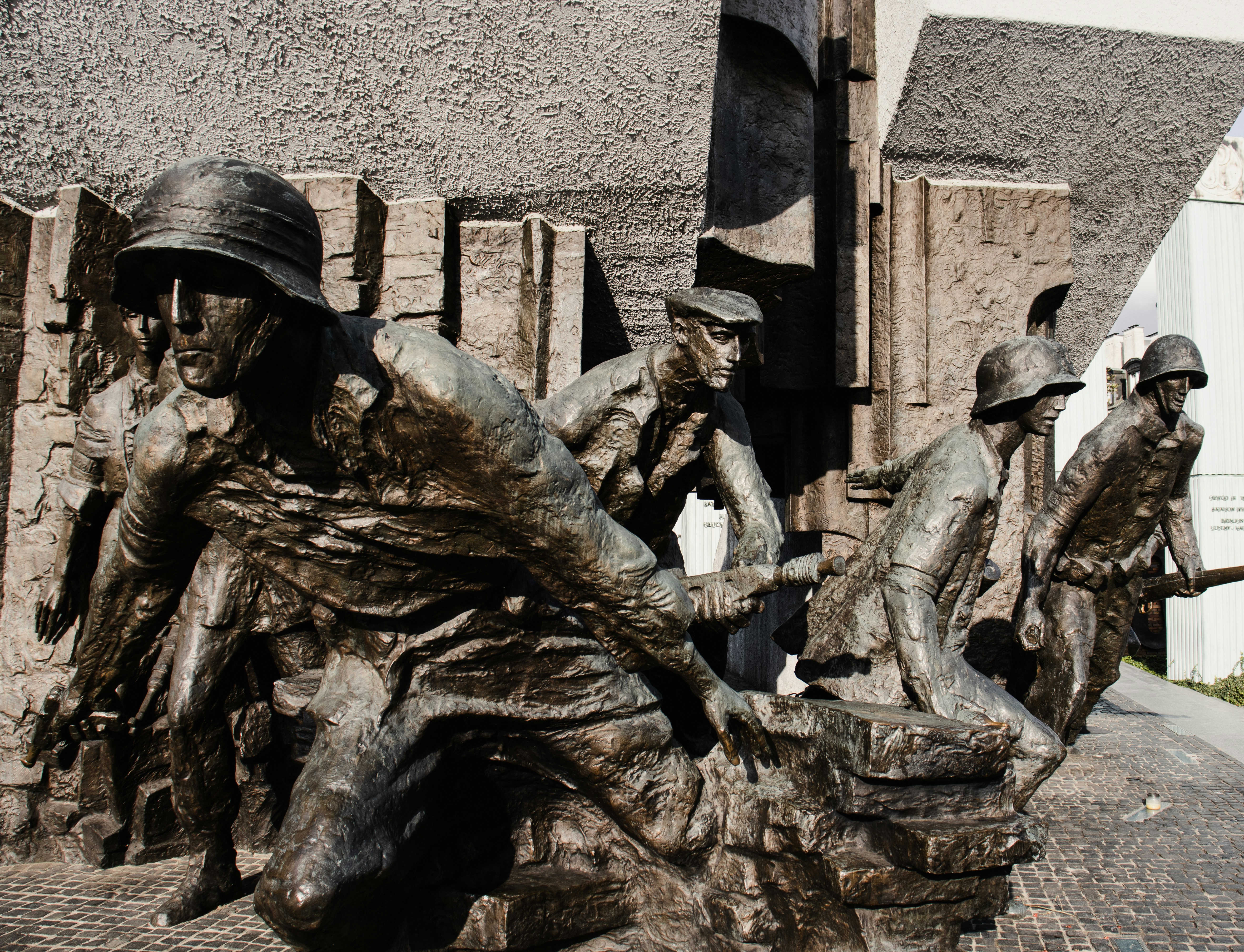 A statue of a group of men riding on top of each other photo – Free ...