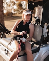 a woman is sitting on a golf cart