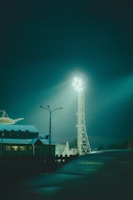 Image capturing outdoor tower lights illuminating a nighttime sports field.
