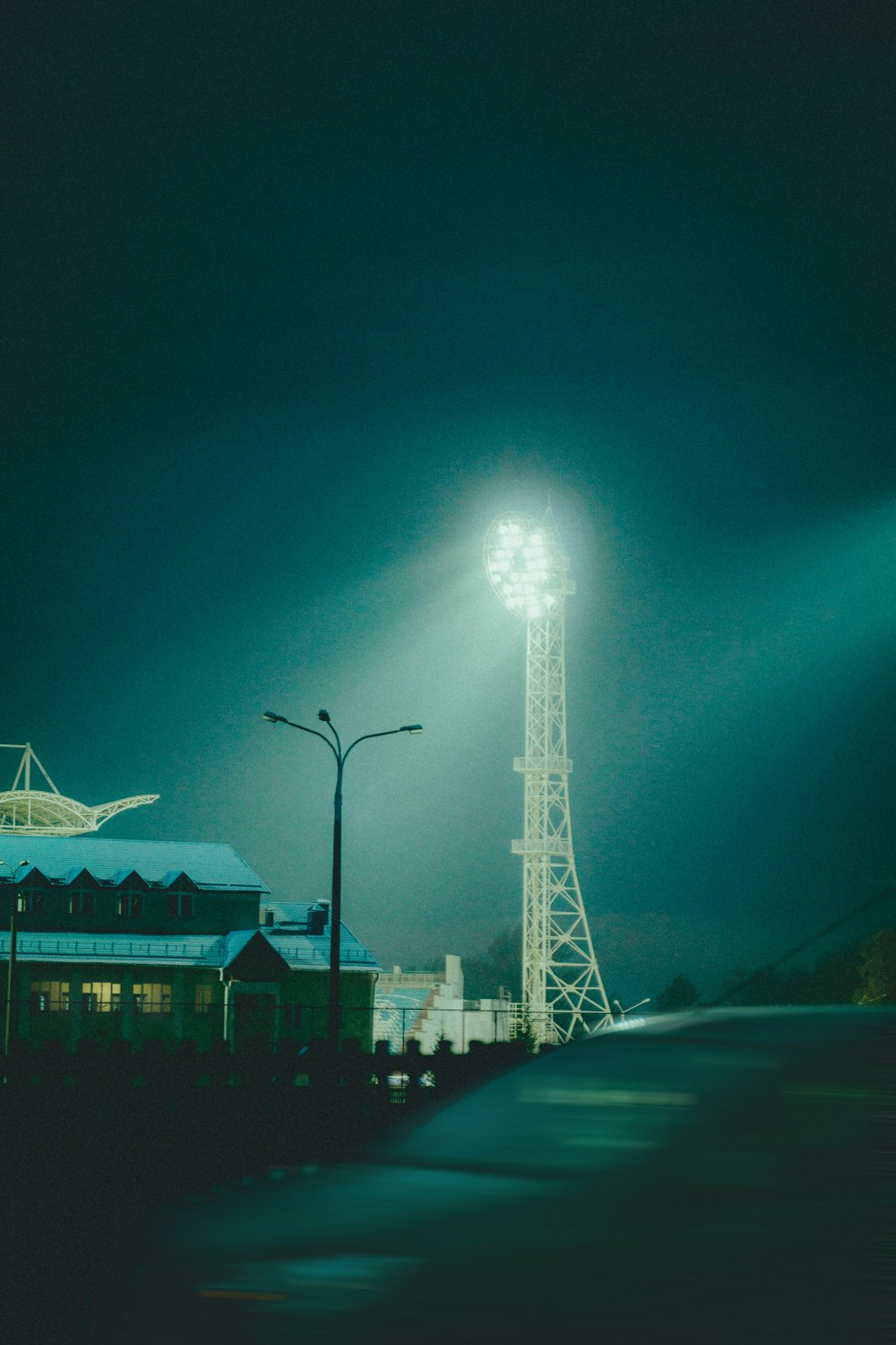 a tall light tower sitting next to a building