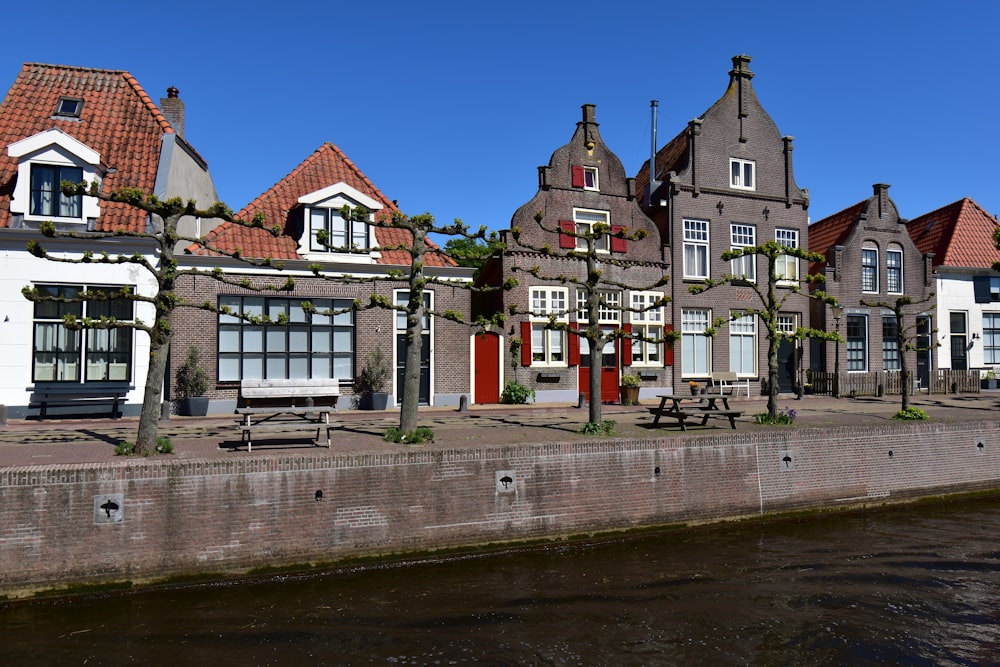 a row of houses next to a body of water