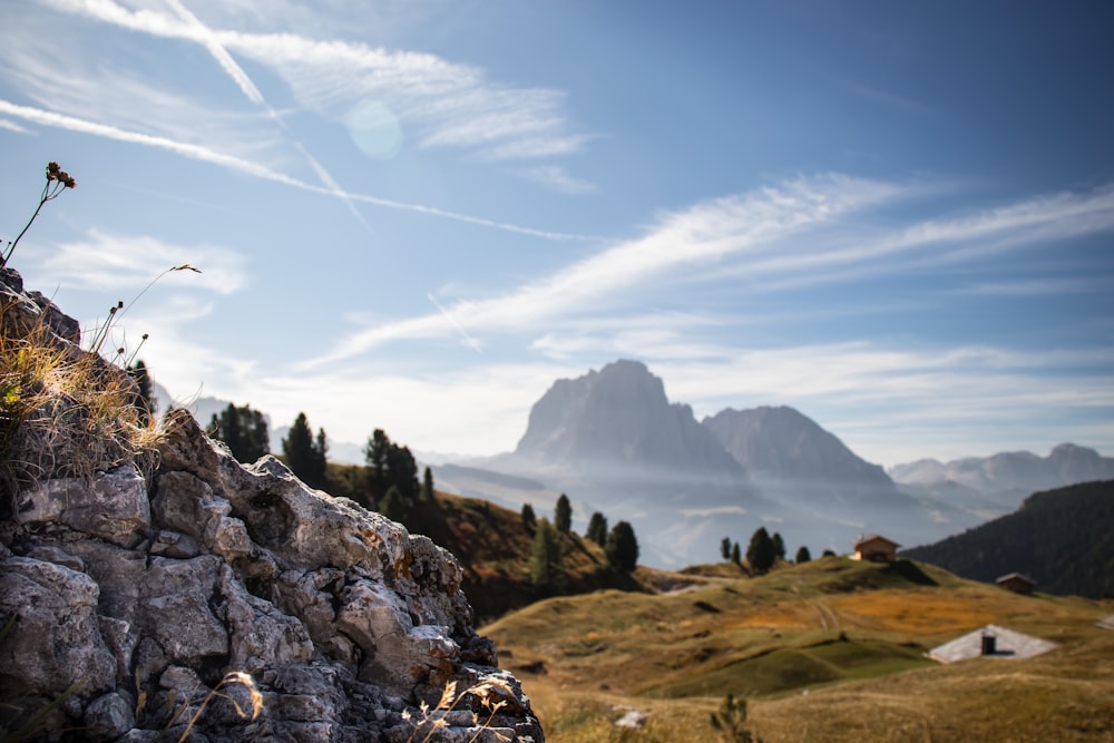 a view of a mountain range with a rock wall in the foreground