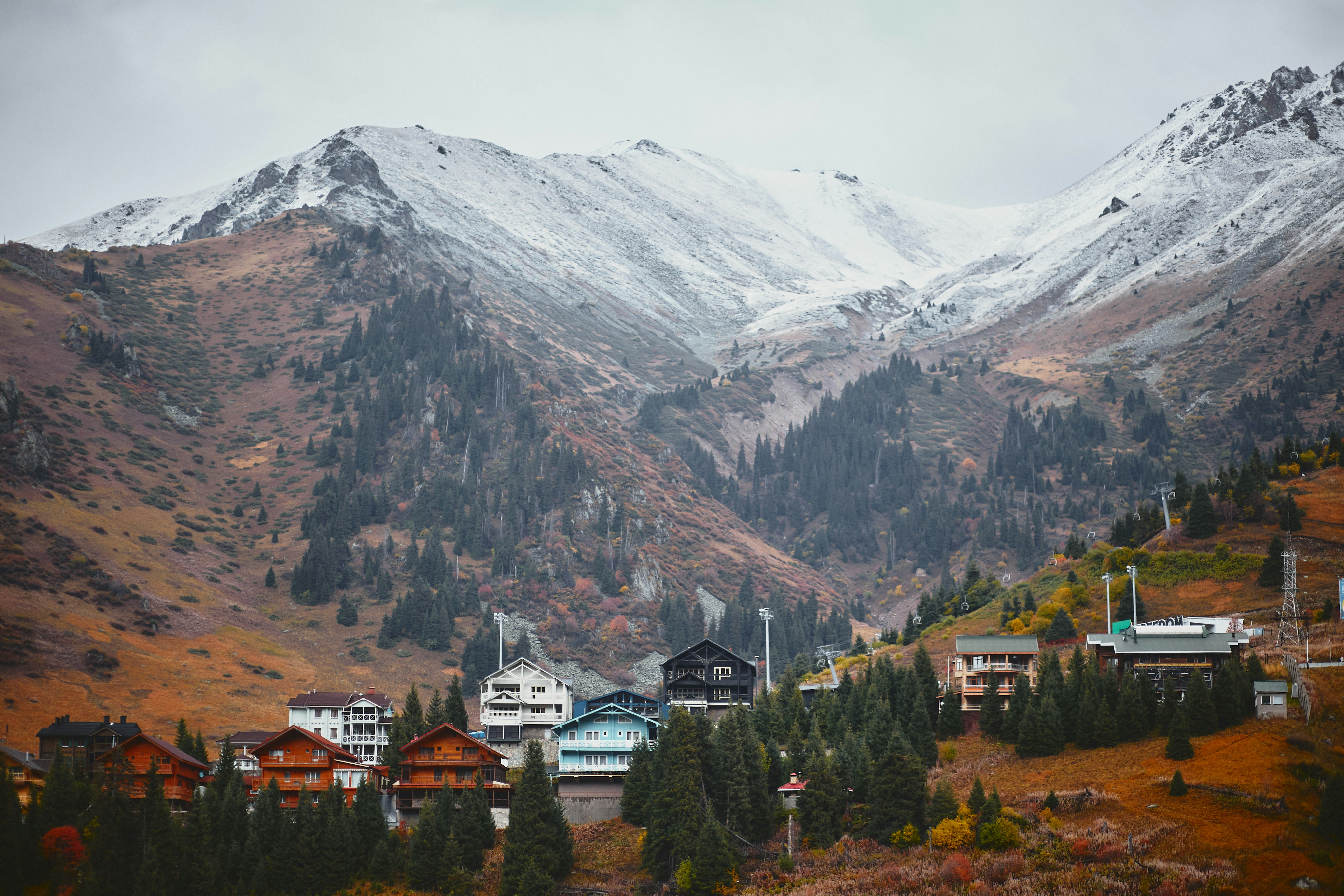 a view of a mountain range with houses in the foreground