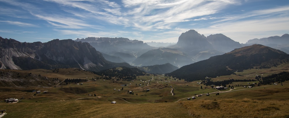 a view of a valley with mountains in the background