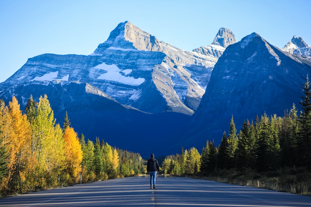 a person walking down the middle of a road