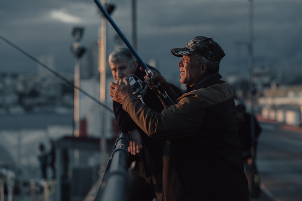 a couple of men standing on top of a boat